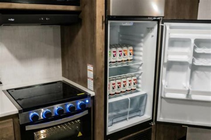 How do I run my RV refrigerator on electric?